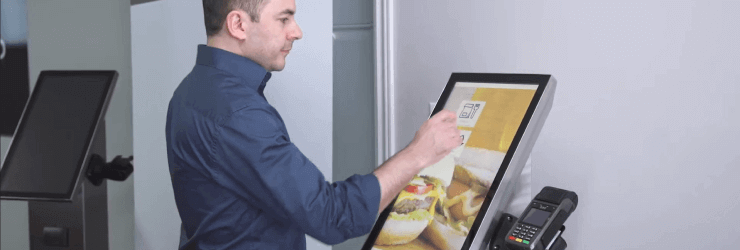 Employee who prepares their order on the self-service ordering kiosk.